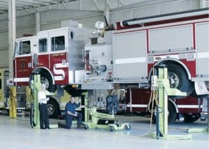 Firefighters perform apparatus maintenance checks on fire truck.
